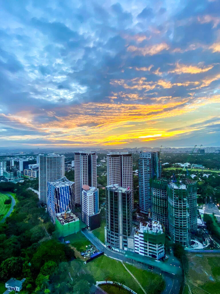 rare digest why more locals and expats are choosing to live in bgc photo of bonifacio global city skyline with sunset views south of bgc