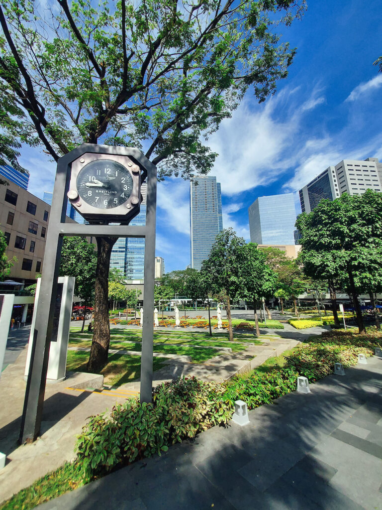 rare digest why more locals and expats are choosing to live in bgc photo of breitling clock in 7th ave bgc central square empty streets, park and scenic green trees in bonifacio global city