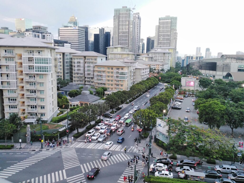 Aerial view of a busy intersection in Makati, Metro Manila, Philippines, showcasing urban life.